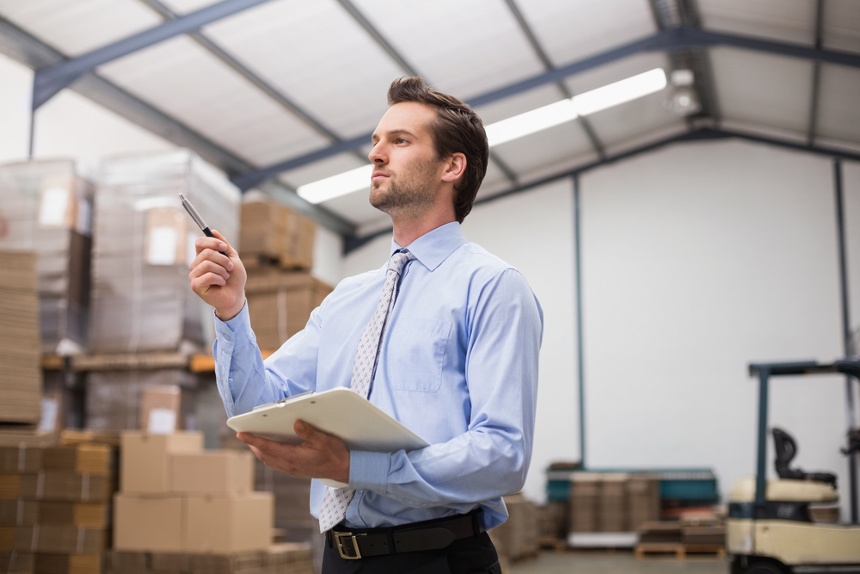 man holding clipboard checking inventory