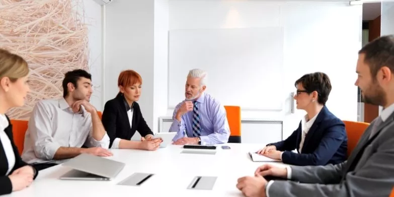 business people group on meeting at modern bright office indoors. Senior businessman as leader in discussion.-1