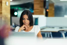 business person using laptop in home office