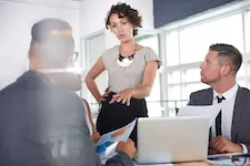 team of business people having a meeting in executive sunlit office