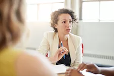 unposed group of creative business people in an open concept office brainstorming their next project