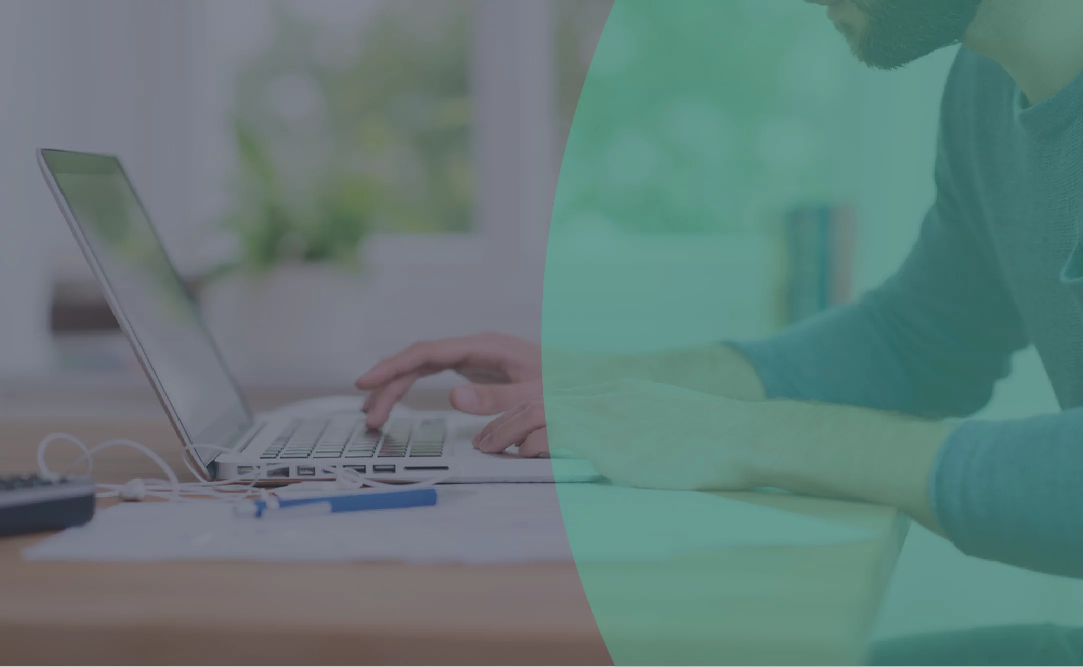 Close up of man working from home on a laptop sitting at a desk